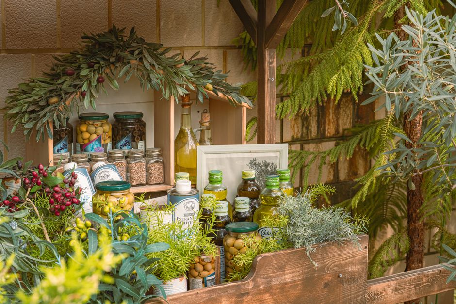 Charming outdoor display of olive oils and herbs, perfect for rustic decor enthusiasts.